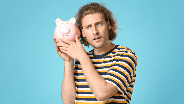 employee confused about budgeting holding a piggy bank
