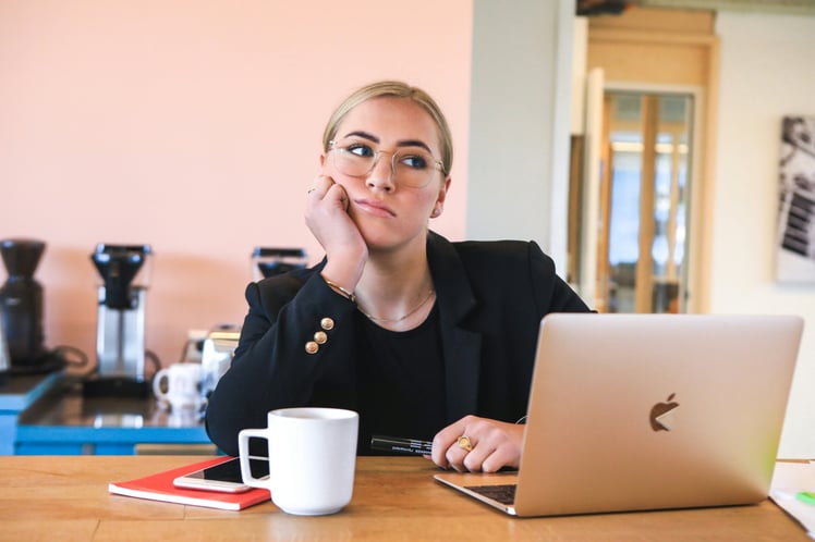Woman in black long sleeve shirt using laptop computer looks 